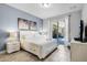 Bright main bedroom featuring tile floors, a blue accent wall, and sliding glass doors to the pool area at 5283 Wildwood Way, Davenport, FL 33837