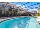 Relaxing pool with a screened enclosure, offering a private outdoor oasis at 5283 Wildwood Way, Davenport, FL 33837