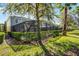 Screened pool and spa surrounded by privacy landscaping enhance this home's outdoor living at 5283 Wildwood Way, Davenport, FL 33837