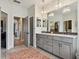 Bright bathroom features double sinks, gray cabinetry, and a large mirror at 600 Statenville Ct, Ocoee, FL 34761