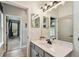 The bathroom features a modern vanity, new lighting, and updated fixtures at 600 Statenville Ct, Ocoee, FL 34761