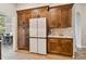 Spacious kitchen featuring dark wood cabinets and modern stainless steel refrigerator at 600 Statenville Ct, Ocoee, FL 34761