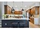 Modern kitchen with granite countertop island, wood cabinets, and stainless steel appliances at 600 Statenville Ct, Ocoee, FL 34761