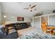 Cozy living room featuring plush furniture, a ceiling fan, and a view of the hallway at 600 Statenville Ct, Ocoee, FL 34761