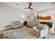 Bright, open-concept living room adjacent to the kitchen with a ceiling fan at 600 Statenville Ct, Ocoee, FL 34761