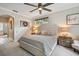 Serene main bedroom with a decorative ceiling fan, stylish decor, and natural light at 600 Statenville Ct, Ocoee, FL 34761