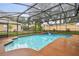 This lovely pool features blue water, a sun shelf, and a screened-in enclosure at 600 Statenville Ct, Ocoee, FL 34761