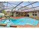 The screened-in pool includes a sun shelf and patio area, perfect for relaxing at 600 Statenville Ct, Ocoee, FL 34761