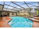 A large in-ground pool and spa are screened in with a screened-in porch off the house at 600 Statenville Ct, Ocoee, FL 34761