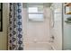 The shower/tub combination features bright white tile and a clear glass window at 600 Statenville Ct, Ocoee, FL 34761