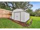 A white storage shed with a new door is behind the house in the backyard at 600 Statenville Ct, Ocoee, FL 34761