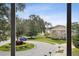 Scenic street view of a well-manicured lawn, fountain, and a blue truck in a circular driveway at 600 Statenville Ct, Ocoee, FL 34761