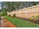 The backyard has a new wooden fence and meticulously manicured landscaping at 600 Statenville Ct, Ocoee, FL 34761