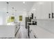 Well-lit kitchen boasts white cabinets, stainless steel appliances, and large island at 6164 Sw 129Th St, Ocala, FL 34473