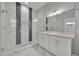 A luxurious bathroom showcasing a glass-enclosed shower with elegant tile and double vanity at 62 W Jersey St # 13, Orlando, FL 32806