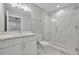 This bathroom features glass enclosed shower, single vanity, and elegant tile at 62 W Jersey St # 13, Orlando, FL 32806