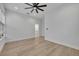 This bedroom features wood floors, white walls, a ceiling fan, and natural light at 62 W Jersey St # 13, Orlando, FL 32806