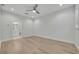 Spacious bedroom features wood floors, ceiling fan, and leads into a connected bathroom at 62 W Jersey St # 13, Orlando, FL 32806