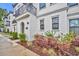 Beautifully landscaped exterior of a townhome with an arched entryway and wrought iron balcony at 62 W Jersey St # 13, Orlando, FL 32806