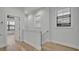 Hallway featuring a staircase and wood flooring at 62 W Jersey St # 13, Orlando, FL 32806