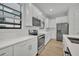 Modern kitchen featuring white cabinetry, stainless steel appliances, and light wood flooring at 62 W Jersey St # 13, Orlando, FL 32806