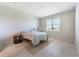 Cozy bedroom features large window, neutral color palette, and tile floors at 6403 Shimmering Shores Ln, St Cloud, FL 34771