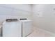 Functional laundry room with a modern washer and dryer set and wire shelving at 6403 Shimmering Shores Ln, St Cloud, FL 34771