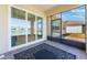 Screened patio overlooks the lake view. A large black rug adorns the brick floor at 6403 Shimmering Shores Ln, St Cloud, FL 34771