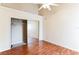 The bedroom has wood floors, a ceiling fan and a closet with sliding mirror doors at 645 Stafford Ter # 162, Altamonte Springs, FL 32714