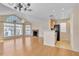 Well-lit living room with a vaulted ceiling, brick fireplace, and seamless transition to the kitchen at 645 Stafford Ter # 162, Altamonte Springs, FL 32714