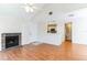 Spacious living room featuring a brick fireplace, laminate flooring, and an open layout leading to the kitchen at 645 Stafford Ter # 162, Altamonte Springs, FL 32714