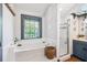 Bright bathroom featuring soaking tub, glass shower and patterned tile floor at 7279 Nena Ct, Mount Dora, FL 32757