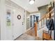 Warm entryway featuring brick flooring, a staircase, and a decorative wreath on the front door at 7279 Nena Ct, Mount Dora, FL 32757