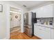 Bright kitchen view showcasing stainless steel refrigerator and doorway to entry at 7279 Nena Ct, Mount Dora, FL 32757