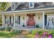 Inviting front porch with brick flooring, seating, planters, and decorative accents at 7279 Nena Ct, Mount Dora, FL 32757