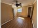 Bedroom featuring wood floors, neutral walls, and a ceiling fan providing a serene living space at 7309 Daniel Webster Dr # D, Winter Park, FL 32792