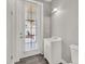 Bathroom features a vanity sink, toilet, shower, and door leading to the outside at 7548 Gathering Dr, Reunion, FL 34747