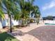 Lush backyard with outdoor kitchen, and a white fence at 814 Chamberlin Trl, St Cloud, FL 34772