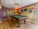 Basement entertainment room featuring a pool table, neon decor, and ample lighting at 814 Chamberlin Trl, St Cloud, FL 34772