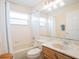 Bright bathroom with a shower and tub and an elegant single sink vanity at 814 Chamberlin Trl, St Cloud, FL 34772