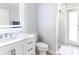 Modern bathroom with white vanity, frameless mirror, and glass-enclosed shower at 814 Chamberlin Trl, St Cloud, FL 34772