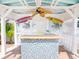 A poolside cabana with a ceiling fan, surfboard decor and a tile bar at 814 Chamberlin Trl, St Cloud, FL 34772