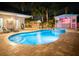 Inviting backyard pool area with a spa, a tiki bar and covered patio, perfect for outdoor entertaining at 814 Chamberlin Trl, St Cloud, FL 34772