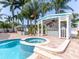 A luxurious pool with a spa and outdoor cabana offers the perfect spot for relaxation at 814 Chamberlin Trl, St Cloud, FL 34772