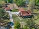 Aerial view showing the home, detached garage, circular driveway, and mature trees at 9272 Gotha Rd, Windermere, FL 34786