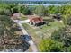 An aerial view displays the property's prime location near the water and landscaping at 9272 Gotha Rd, Windermere, FL 34786