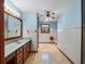 Bright bathroom featuring hexagon tile floors, vanity with sink, and blue walls at 9272 Gotha Rd, Windermere, FL 34786