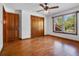 Bedroom with hardwood floors, closet, and window with blinds at 9272 Gotha Rd, Windermere, FL 34786