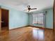 Bright bedroom with hardwood floors, and a private door at 9272 Gotha Rd, Windermere, FL 34786