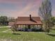 A daytime view shows this house's facade, front lawn, and exterior landscaping at 9272 Gotha Rd, Windermere, FL 34786